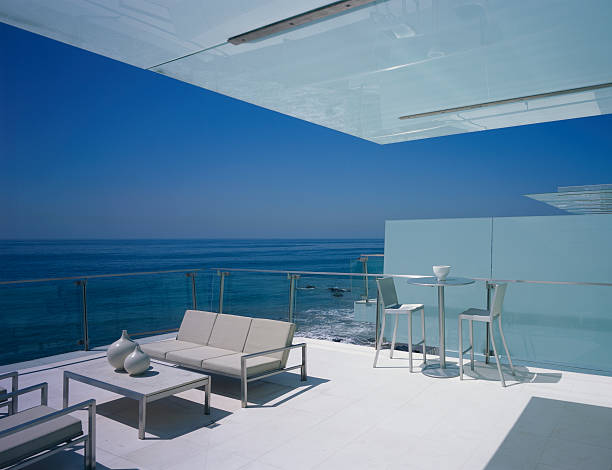 Luxury coastal terrace overlooking Pacific Ocean at golden hour